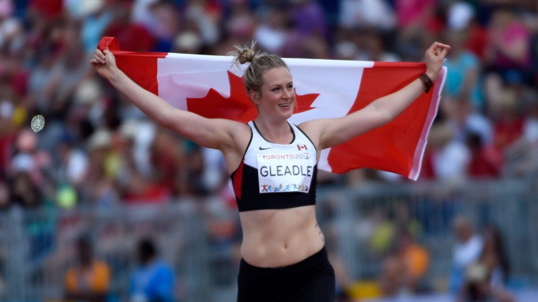 Liz Gleadle Holding Canadian Flag during her victory lap