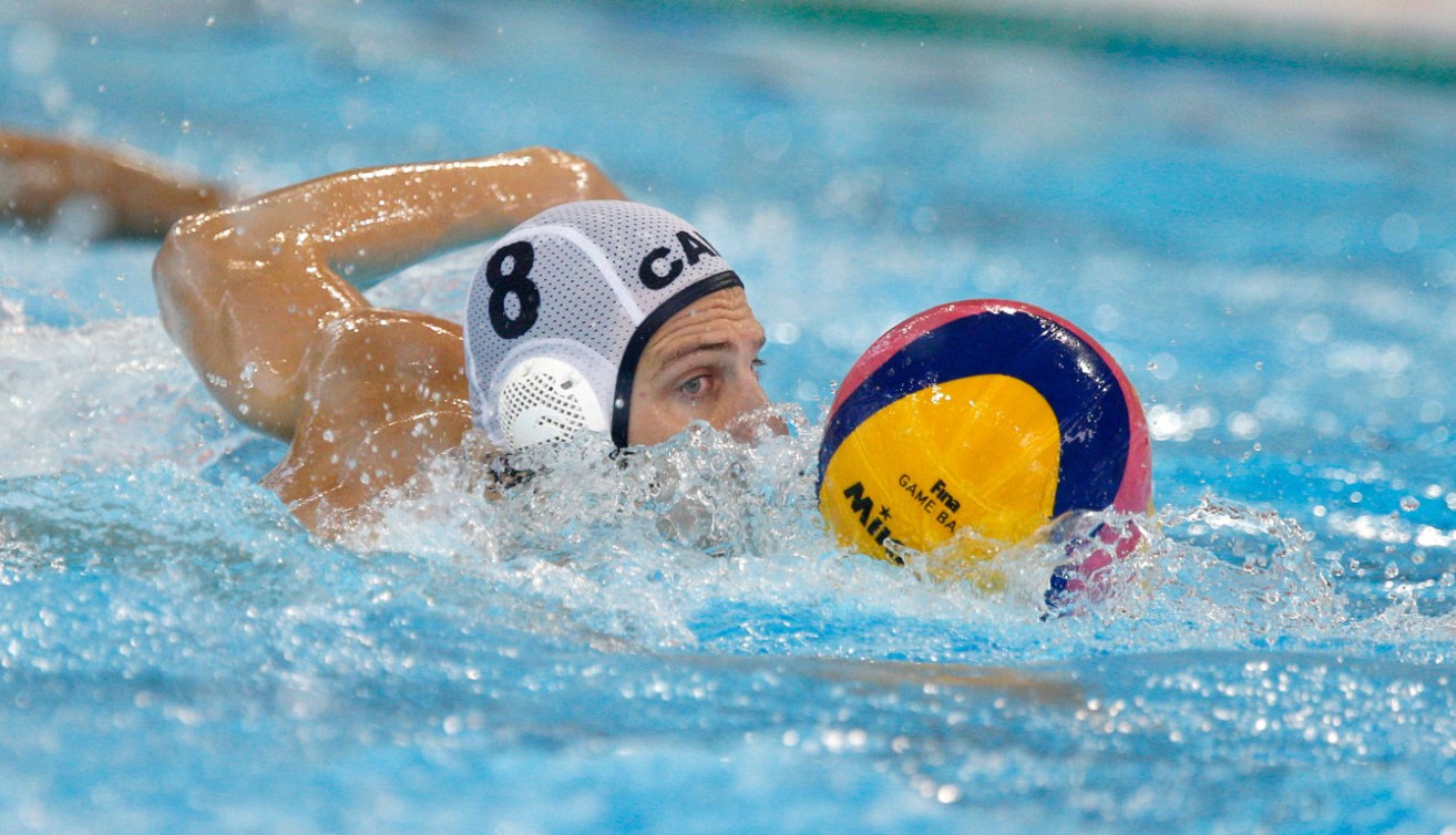 Kevin Graham moves the ball during the men's water polo bronze medal match. (Photo: Michael Hall)