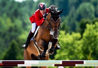 Ian Millar jumping in equestrian at Olympic Games