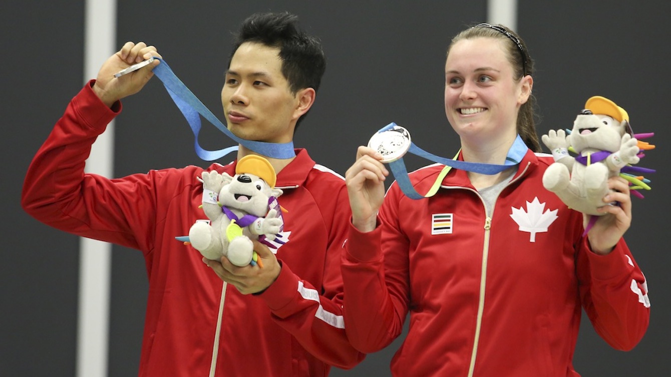 Alex Bruce (right) of Toronto and Toby Ng of Vancouver show off their silver medal in mixed doubles badminton finals play at the PanAmerican Games in Markham, Ont. Photo by Mike Ridewood