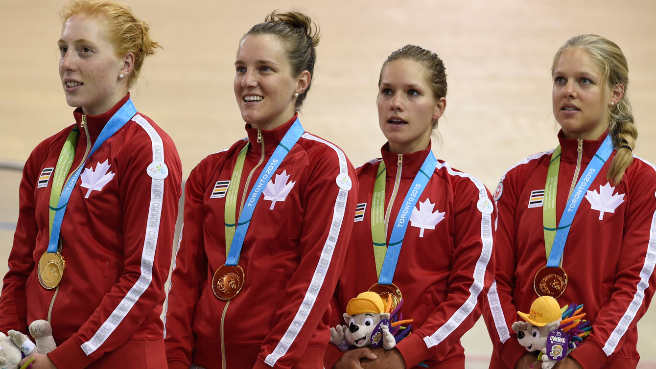 Allison Beveridge, Laura Brown, Jasmin Glaesser and Kirsti Lay sing the national anthem after winning Pan Am Games gold in women's team pursuit on July 17, 2015.