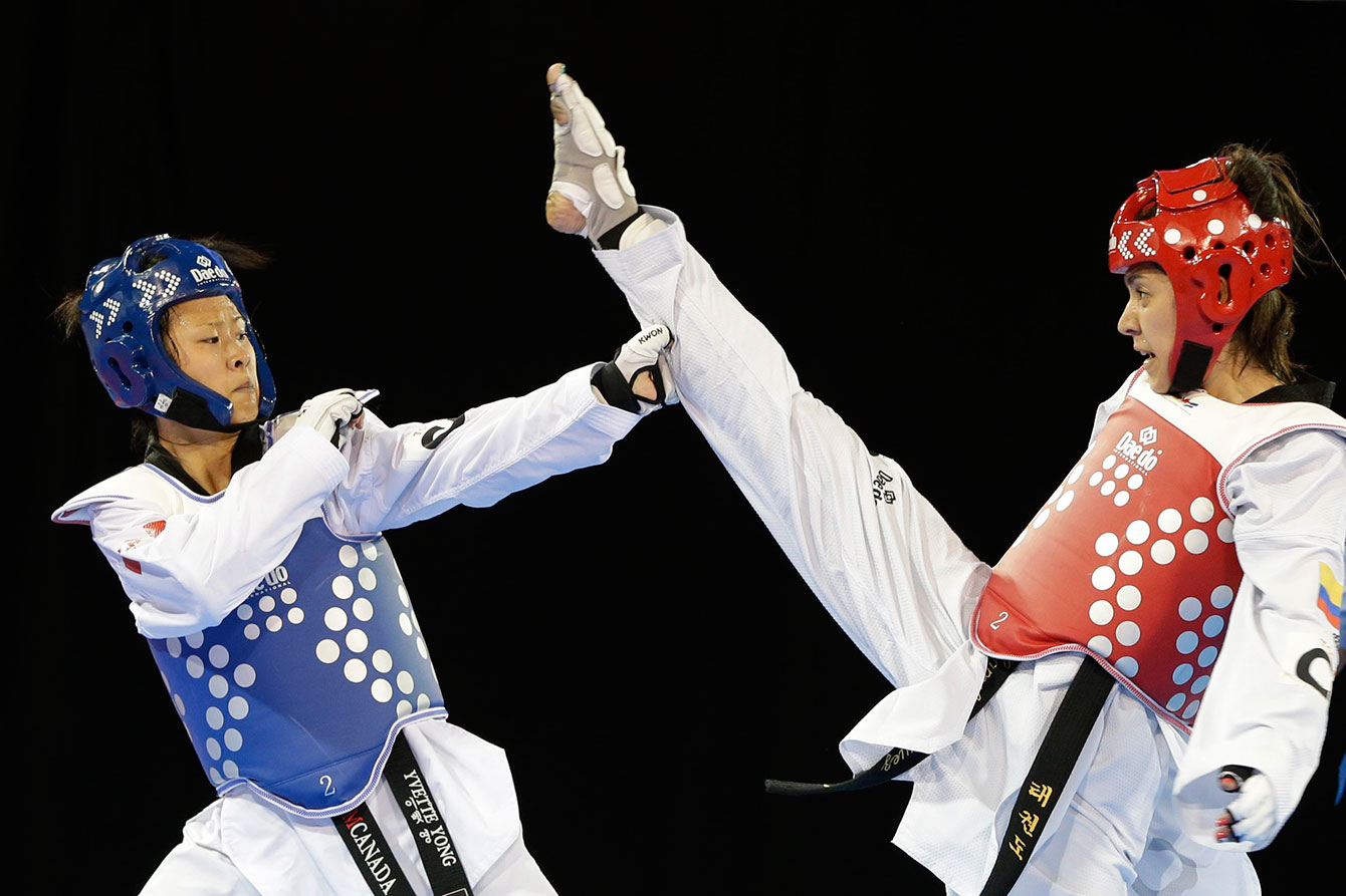 Yvette Yong avoids a kick from Colombia's Ibeth Rodriguez during their quarterfinal. Yong won this one but went on to lose her semifinal.