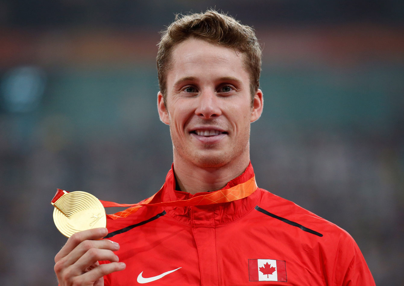 High jumper Derek Drouin holds up his gold medal at the IAAF World Championships in Athletics on August 30, 2015.