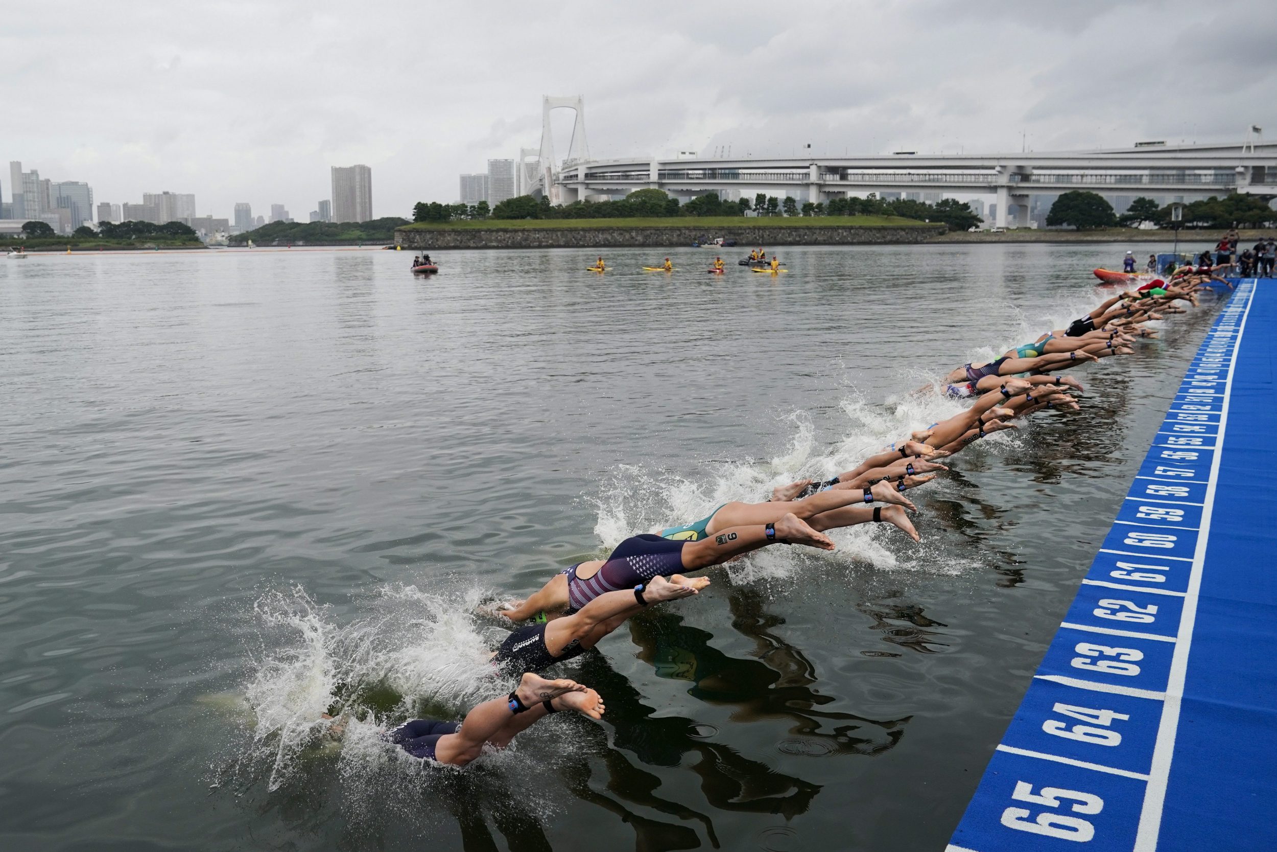 Women dive into water at Triathlon test event at the Odaiba Marine Park