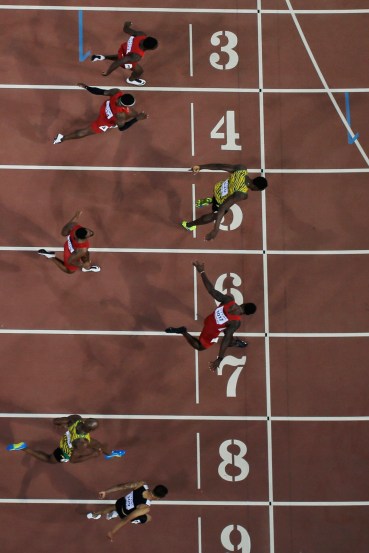 Andre De Grasse, Usain Bolt, Justin Gatlin Andre De Grasse (lane nine) leans in for bronze as Usain Bolt (5) and Justin Gatlin (7) battle for gold and silver in the closing moments of the 100m final at the IAAF World Championships in Athletics in Beijing, China on August 23, 2015.