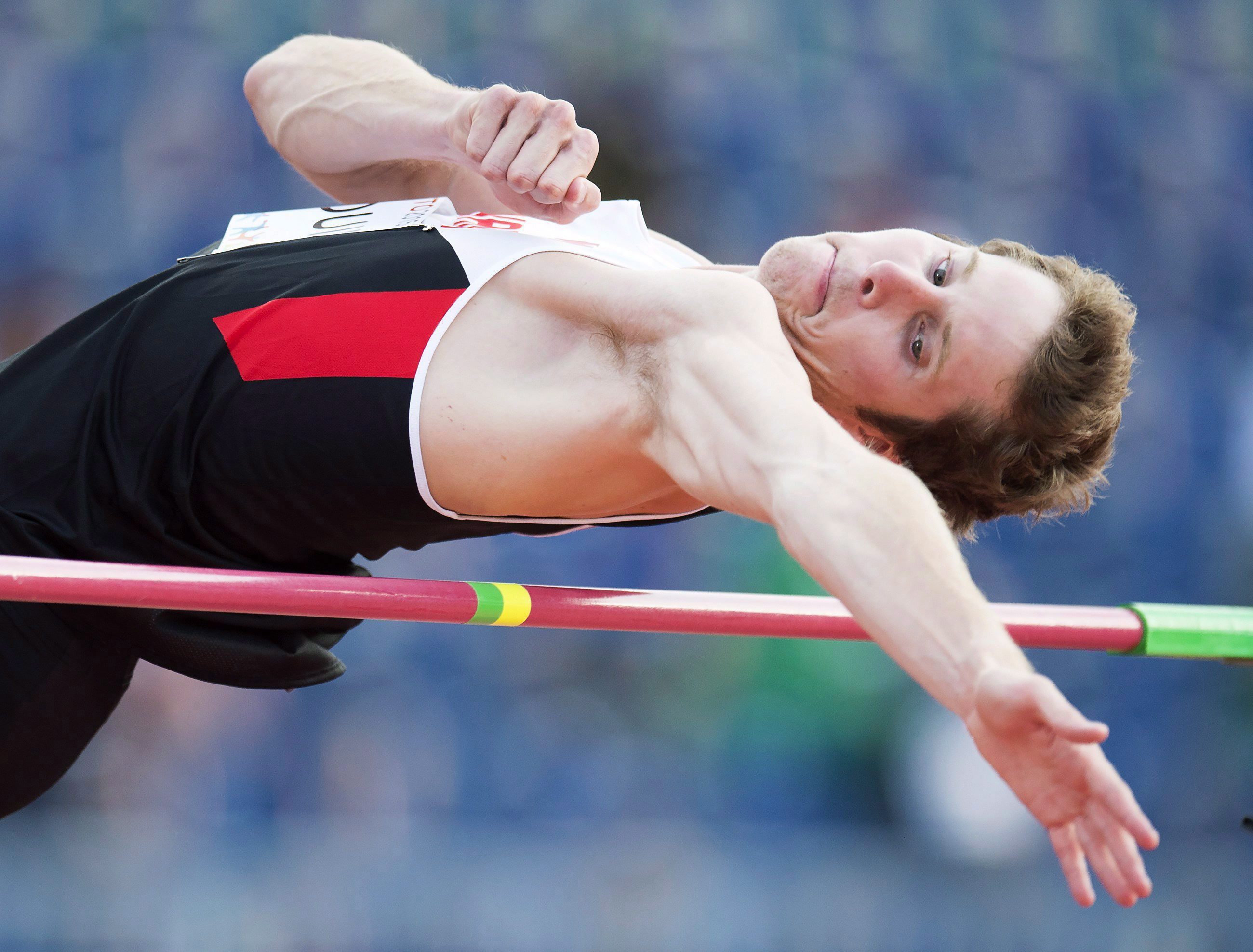 Derek Drouin clears the bar in the men's high jump final