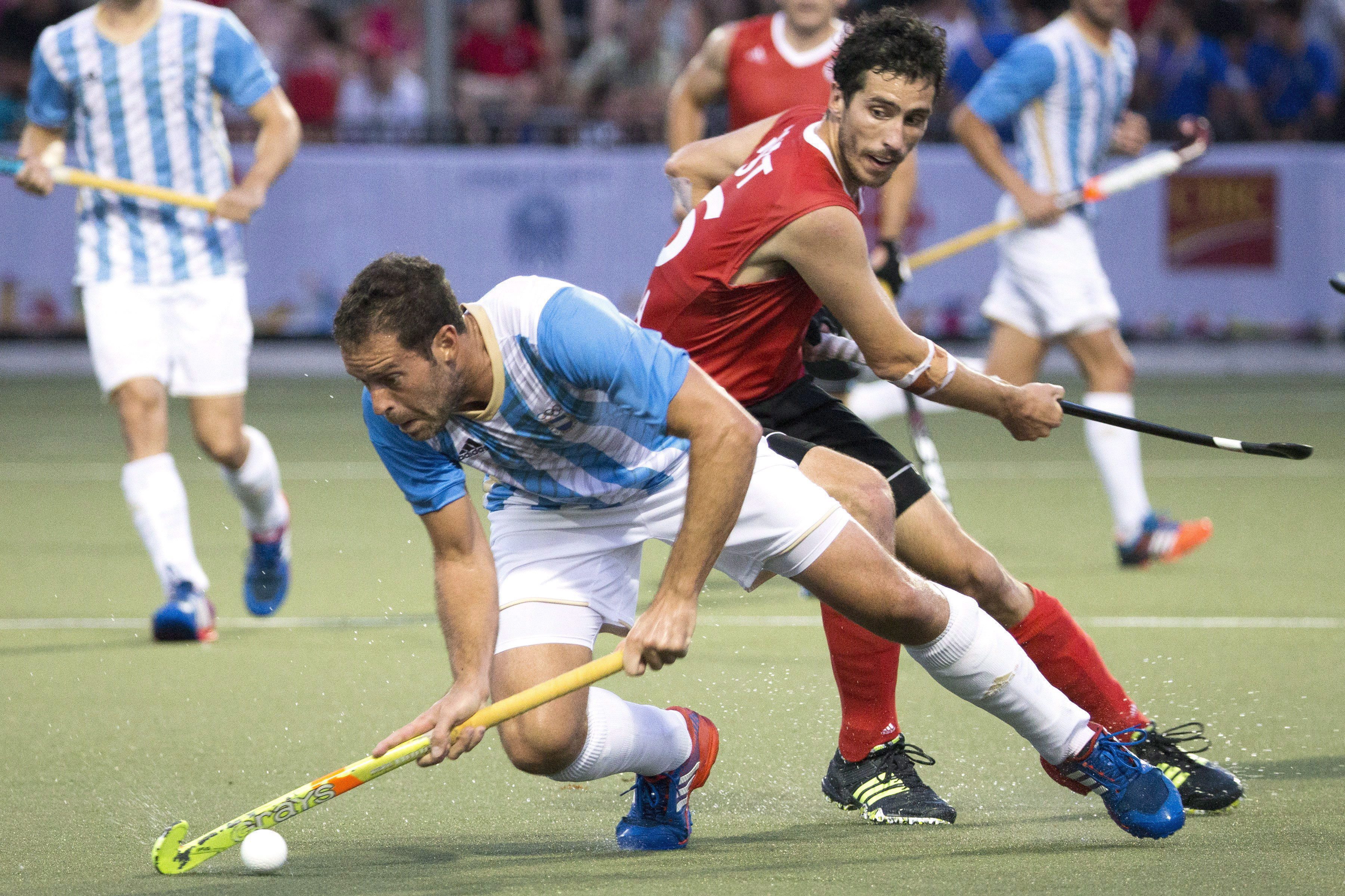 Argentina's Juan Gilardi, left, turns away from Canada's Matthew Guest