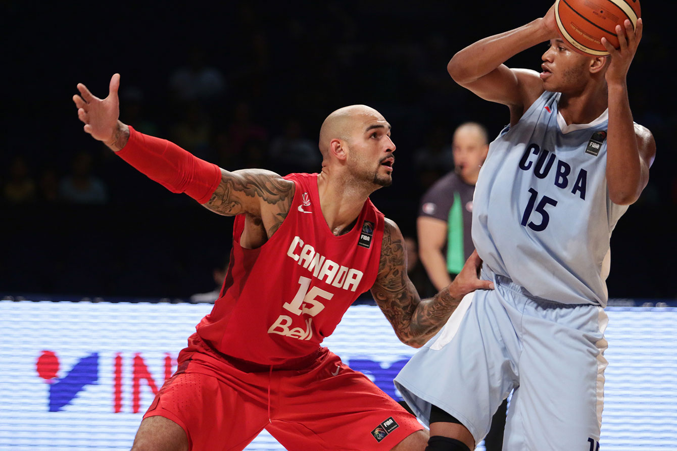 Robert Sacre (left) had five points and three rebounds in 14 minutes off the pine for Canada.