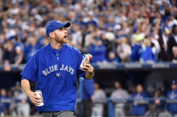 09746751 Sometimes having hockey fans at a baseball game can get a bit intense. In Game 5, Jays fans pelted the field with beer cans and other debris during an 18-minute delay following a controversial call by the umpires.