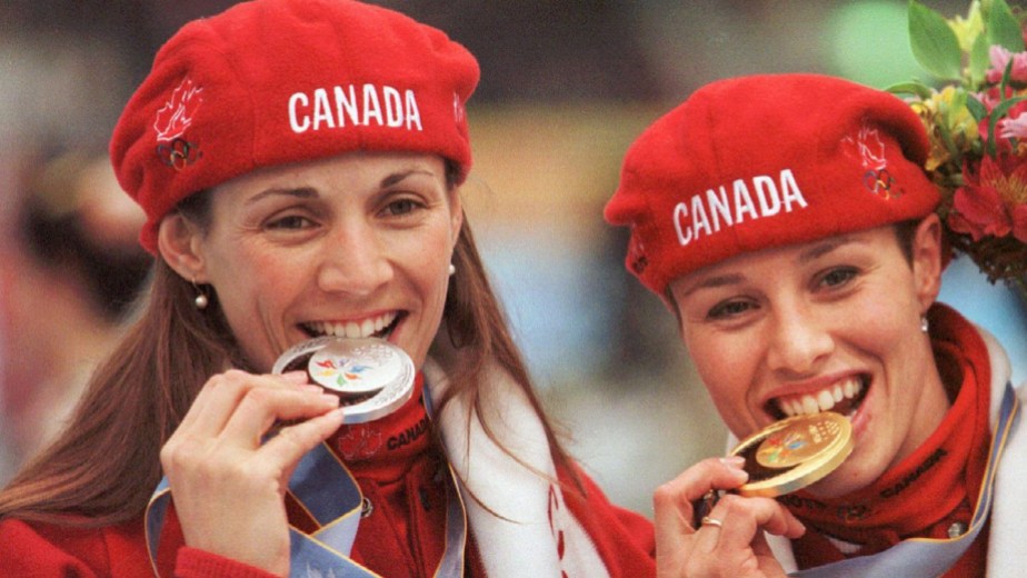 1357715 Susan Auch and Catriona Le May Doan bite their medals