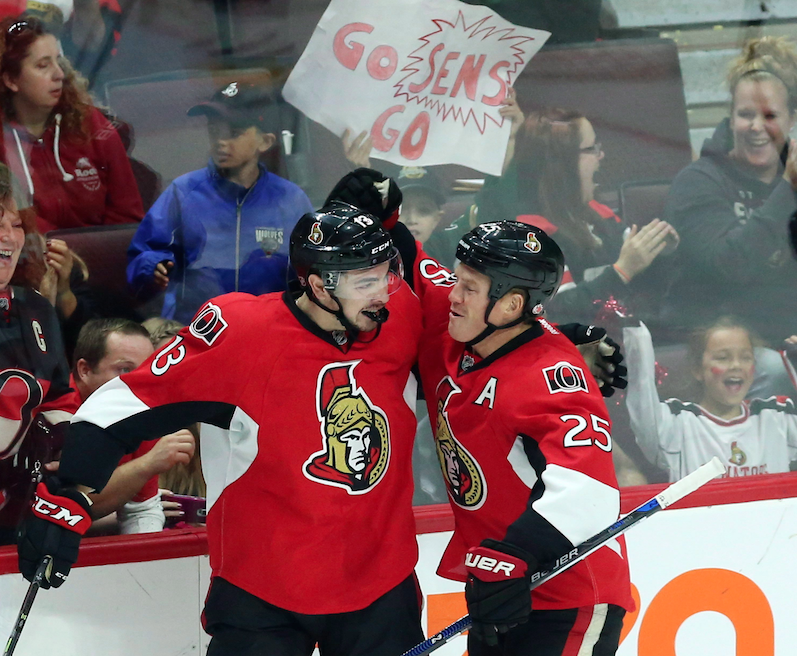 Ottawa Senators' Nick Paul (13)celebrates his goal with teammate Chris Neil (25) during second period NHL pre-season hockey against the Bufallo Sabres in Ottawa Saturday September 26, 2015.