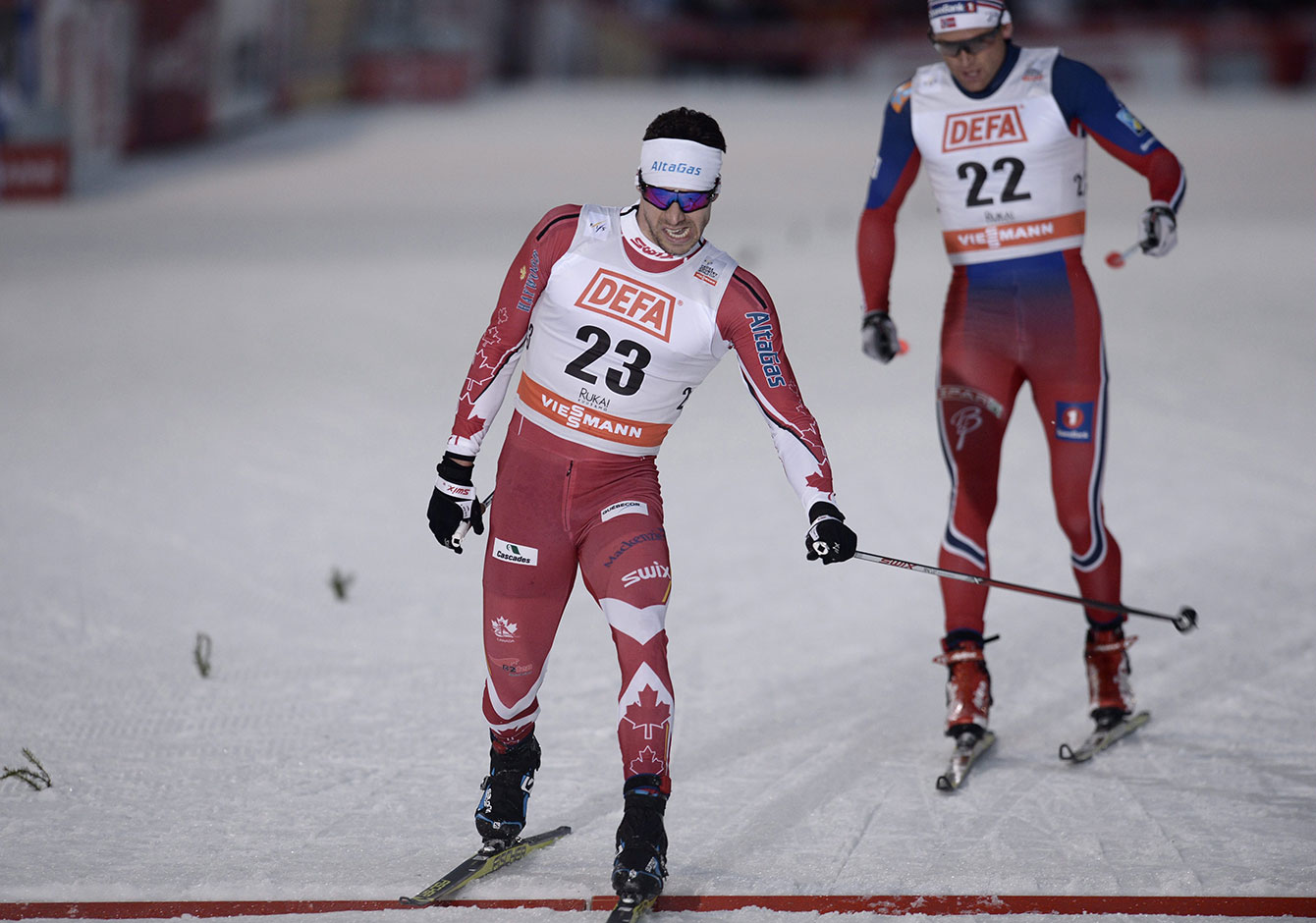 Alex Harvey edges Dario Cologna of Switzerland in Kuusamo, Finland to win World Cup skate-ski silver on November 28, 2015. 
