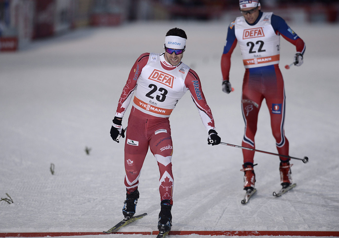 Alex Harvey edges Dario Cologna of Switzerland in Kuusamo, Finland to win FIS World Cup skate-ski silver on November 28, 2015.