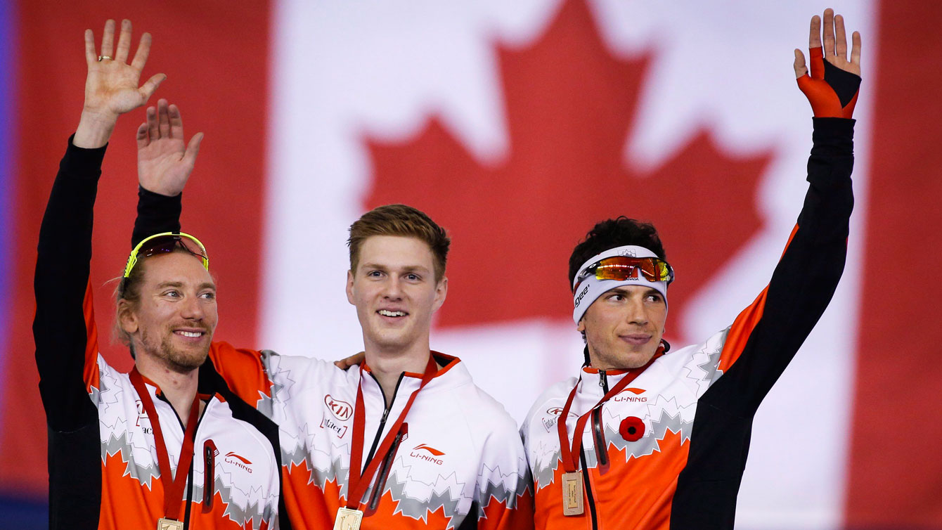 (L-R) Ted-Jan Bloemen, Benjamin Donnelly and Jordan Belchos celebrate team pursuit World Cup gold in Calgary on November 14, 2015.