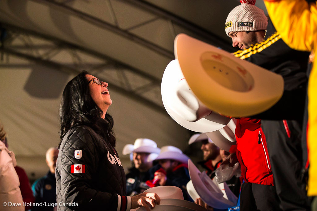 Canadian Olympic Committee president Tricia Smith hands out prizes at the podium following the doubles and women's competitions at the Luge World Cup in Calgary on December 18, 2015. 