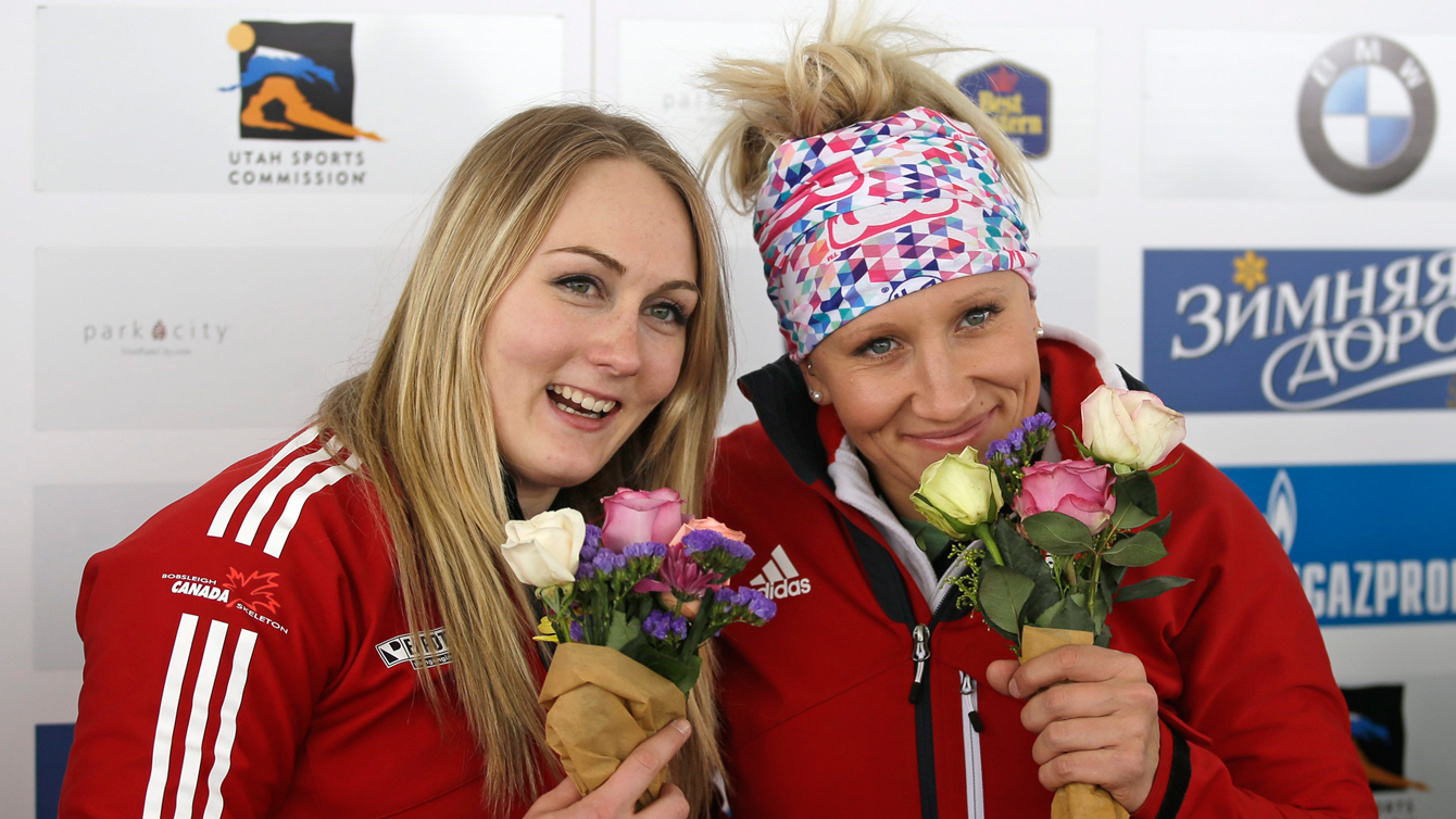 Kaillie Humphries, right, and Melissa Lotholz pose during the flower ceremony after winning the women's bobsleigh World Cup race January 15, 2016, in Park City, Utah. 