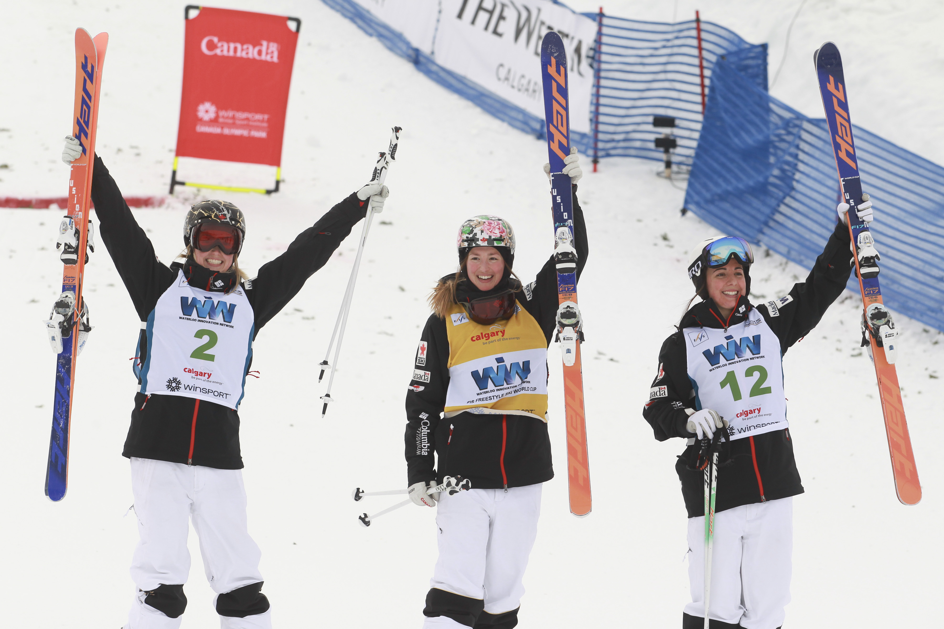 The top three in women's moguls at the FIS freestyle ski World Cup in Calgary, January 30, 2016. From left, Justine Dufour-Lapointe (second), Chloe Dufour-Lapointe (first) and Andi Naude. (Photo: Mike Ridewood/CFSA)