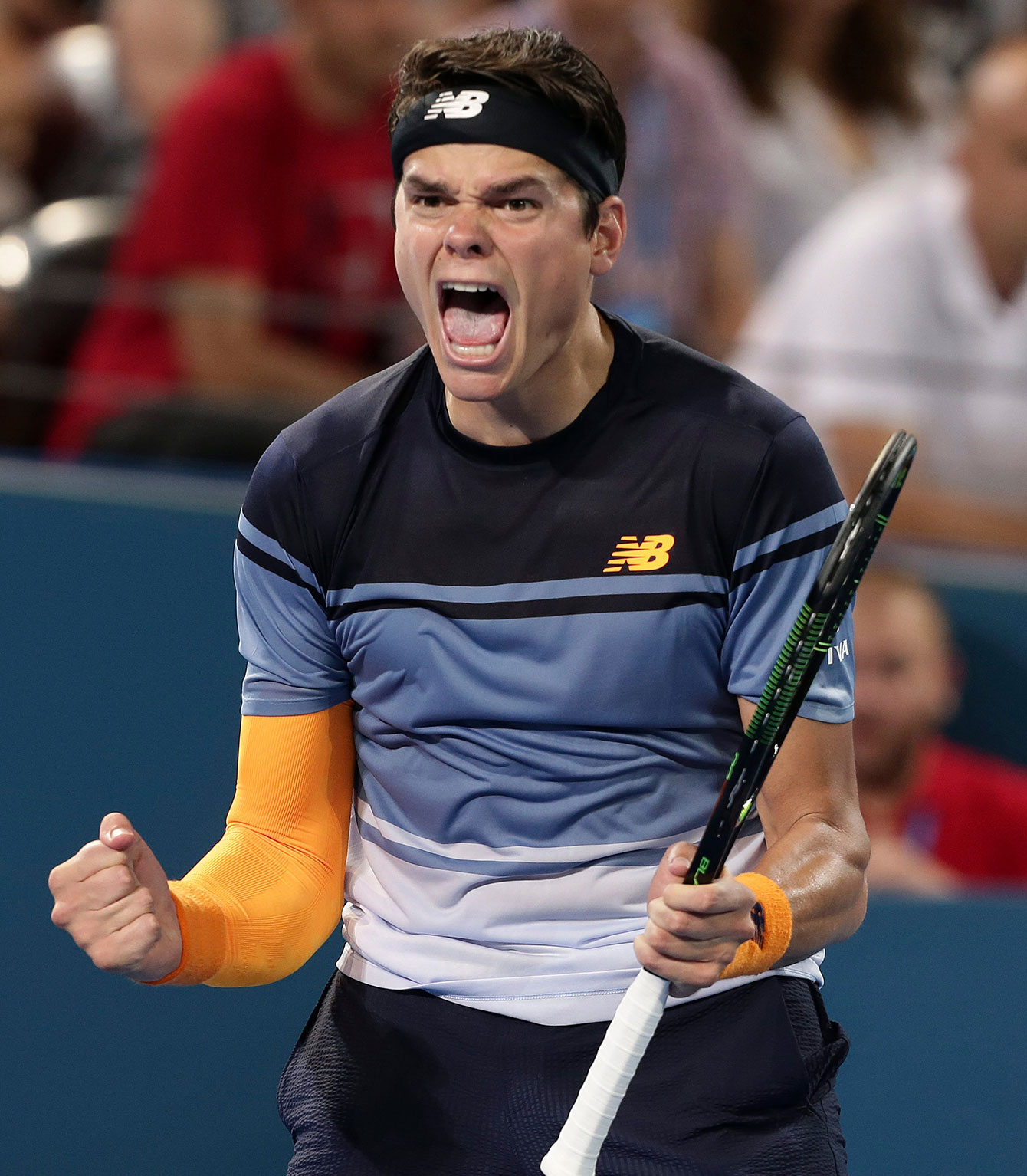 Milos Raonic celebrates winning the Brisbane International final where the Canadian beat Roger Federer 6-4, 6-4 on January 10, 2016. 