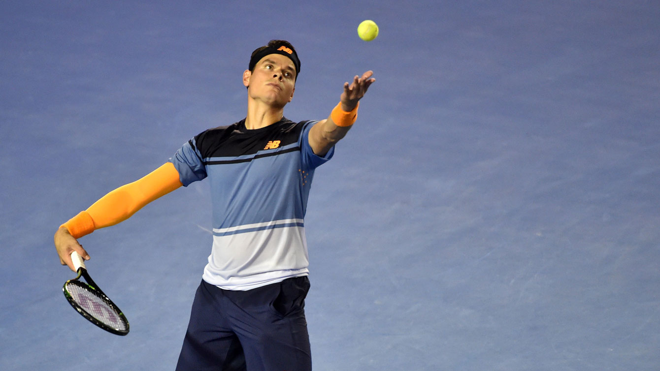 Milos Raonic serves against Gael Monfils at the Australian Open on January 27, 2016. 