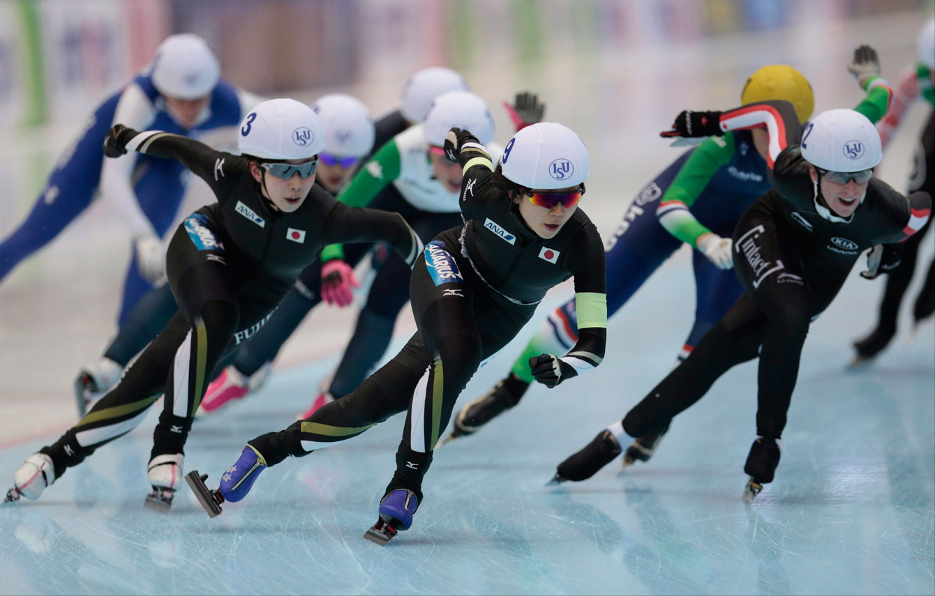 From left, Oshigiri Misaki, Takagi Miho, both of Japan, and Ivanie Blondin, of Canada, lead the pack on the last lap of the women's mass start race of the speedskating single distance World Championship