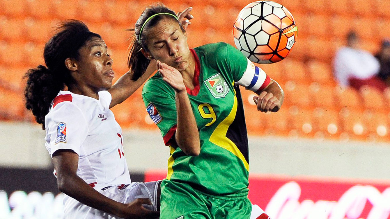 Ashley Lawrence (left) goes for a ball against Ashley Rodrigues of Guyana on February 11, 2016. 