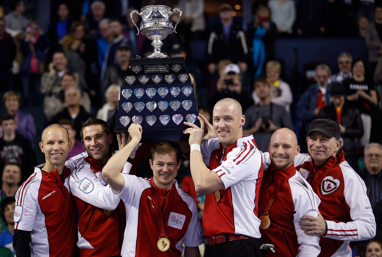 Team Canada skip Pat Simmons, left to right, third John Morris, second Carter Rycroft, lead Nolan Thiessen, alternate Tom Sallows, and coach Earl Morris, lift the Brier Tankard after defeating Northern Ontario to win the gold medal game at the Brier in Calgary on Sunday, March 8, 2015. (Photo: CP/Jeff McIntosh)