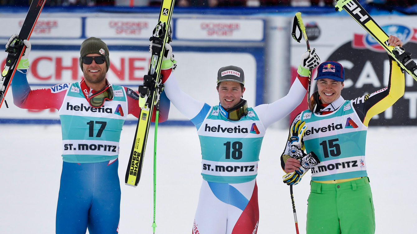 Erik Guay celebrates with the men's downhill medallists at the FIS Alpine Ski World Cup Finals, in St. Moritz, Switzerland on March 16, 2016. (Gian Ehrenzeller/Keystone via AP)