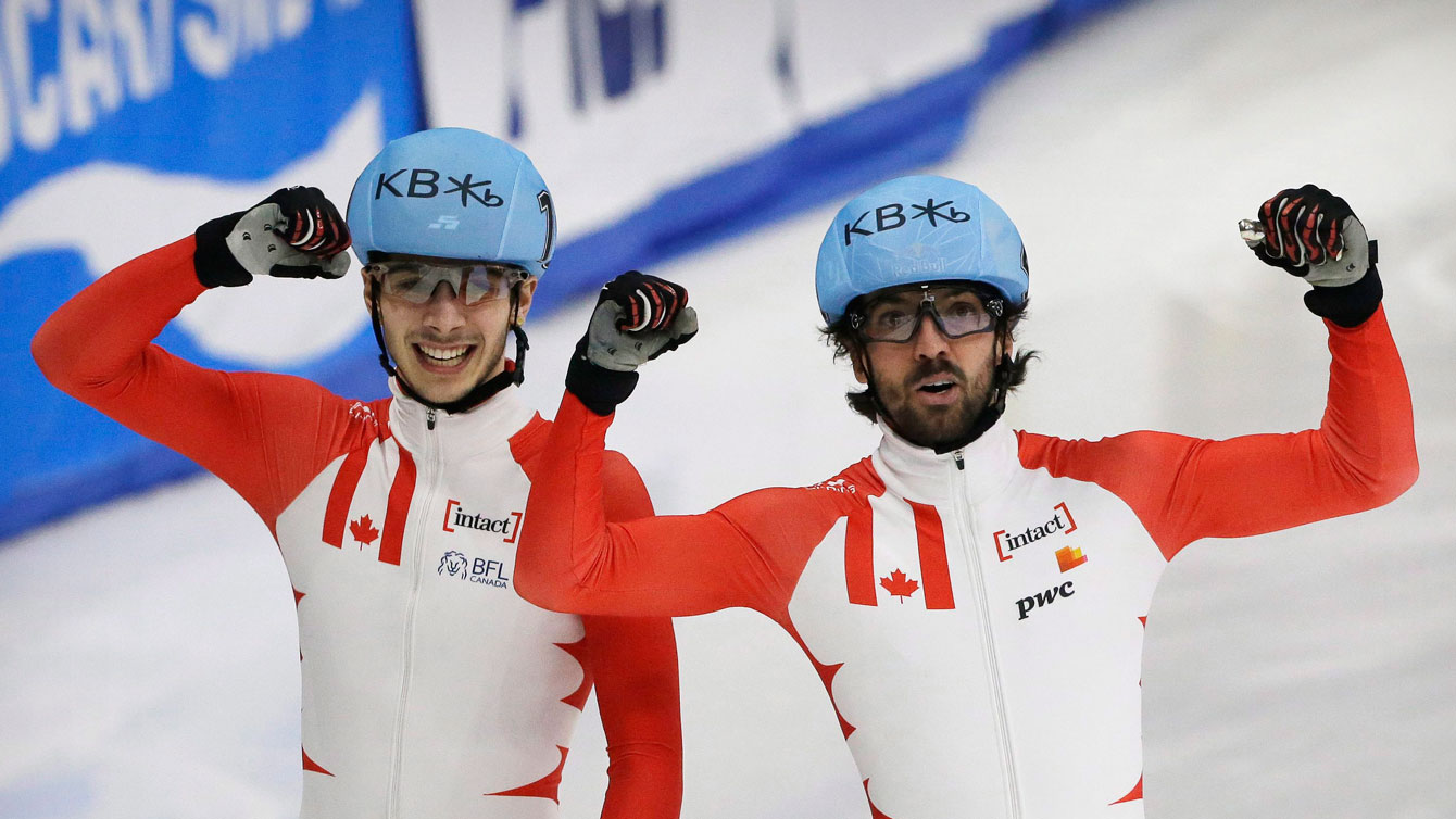 Charles Hamelin, right, and Samuel Girard of Canada celebrate after the men's 1000 metre final at the ISU World Short Track Speed Skating Championships in Seoul, South Korea, Sunday, March 13, 2016. Hamelin won the race while Girard took second. (AP Photo/Ahn Young-joon)