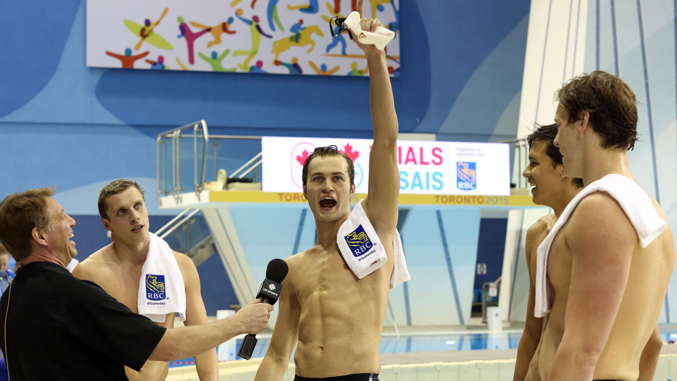 Yuri Kisil (centre) celebrates as Santo Condorelli (left), Markus Thormeyer and Evan Van Moerkerke (right) look on after the four of them qualified to be the Olympic 4x100m-freestyle relay team at Rio Trials in Toronto on April 8, 2016 (Photo: Scott Grant via Swimming Canada). 