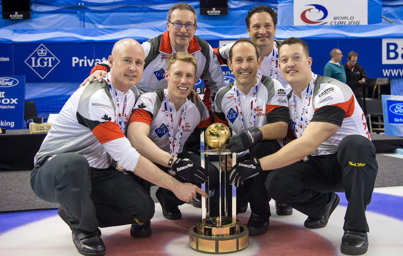 (Front L-R) Kevin Koe, Marc Kennedy, Brent Laing, Ben Hebert. (Back L-R) Coach John Dunn and alternate Scott Pfeifer with the world championship trophy on April 10, 2016. 
