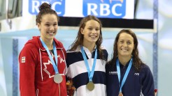 (L-R) Chantal Van Landeghem, Penny Oleksiak, Sandrine Mainville receiving their women's 100m freestyle medals from Rio Trials on April 9, 2016 (Scott Grant via Swimming Canada).