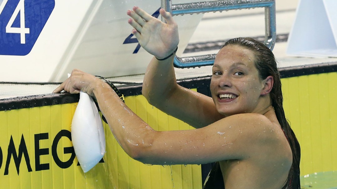 Penny Oleksiak waves after a race