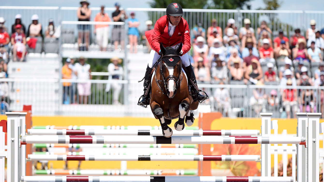Eric Lamaze of Canada competes in the team Equestrian jumping final during the Pan American Games in Caledon, Ont. on July 23, 2015. THE CANADIAN PRESS/Nathan Denette