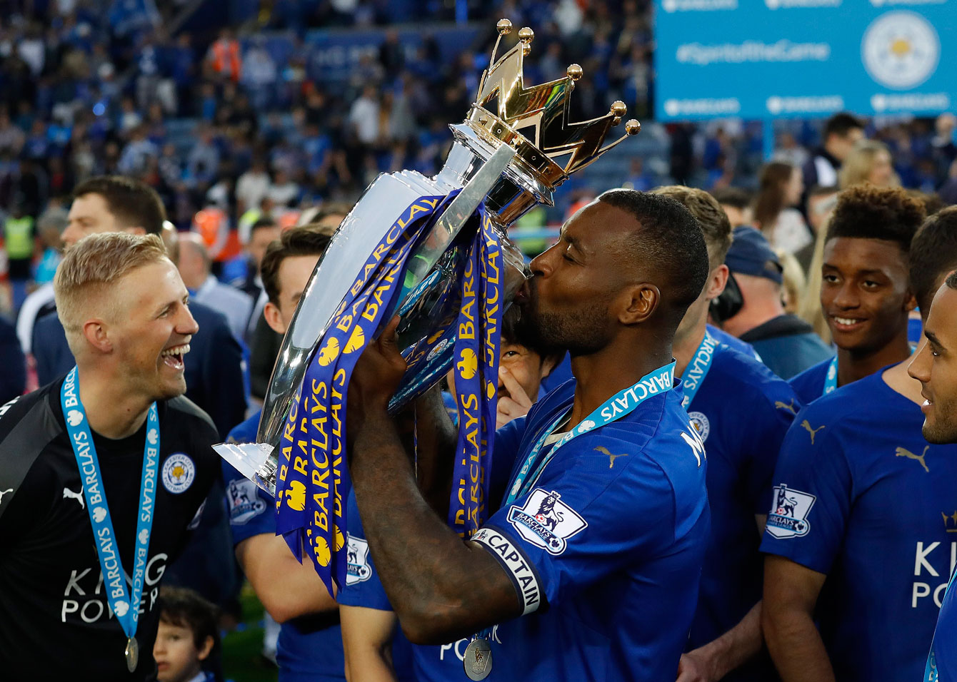 Wes Morgan, captain of Leicester City FC, kisses the English Premier League trophy on May 7, 2016.