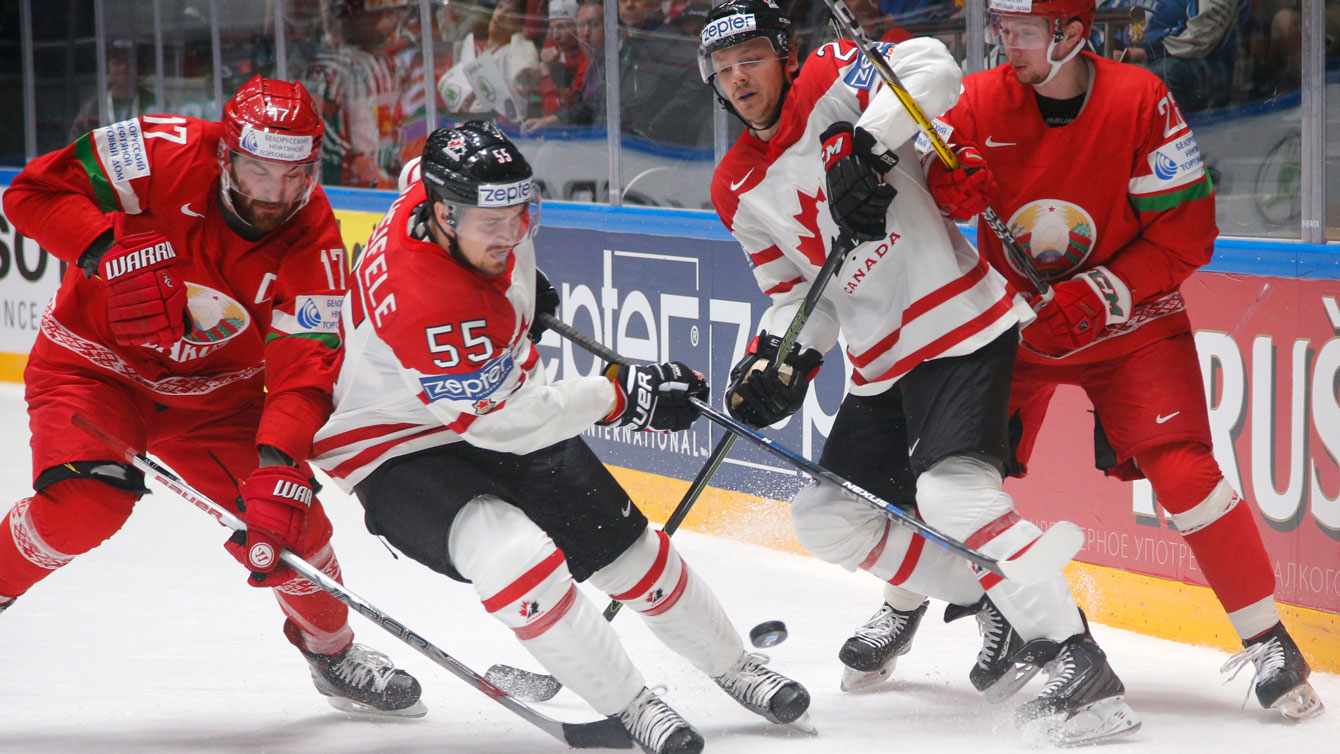 Mark Scheifele and Sam Reinhart fight for the puck at the Hockey World Championships in St.Petersburg, Russia, on May 9, 2016. (AP Photo/Dmitri Lovetsky)