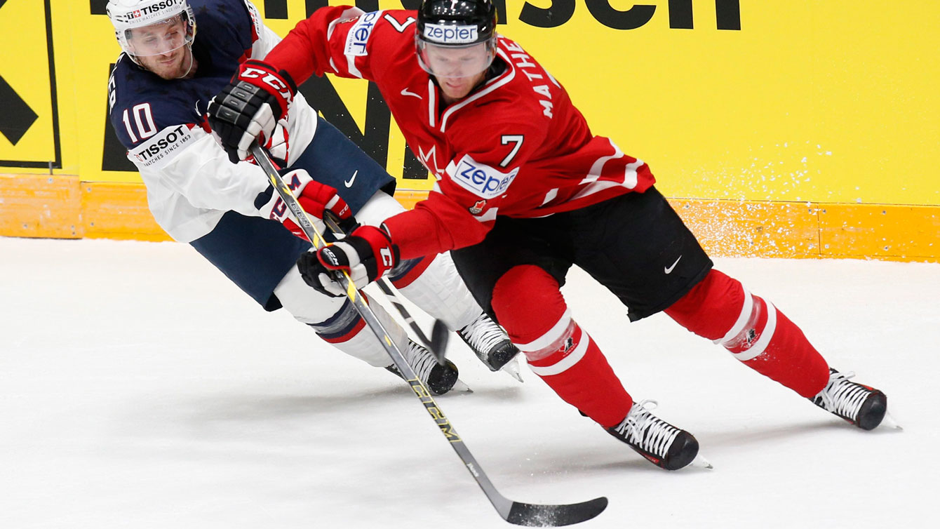 Michael Matheson holds off Jordan Schroeder of the United States at the IIHF World Championships in St.Petersburg, Russia on May 6, 2016. (AP Photo/Dmitri Lovetsky)