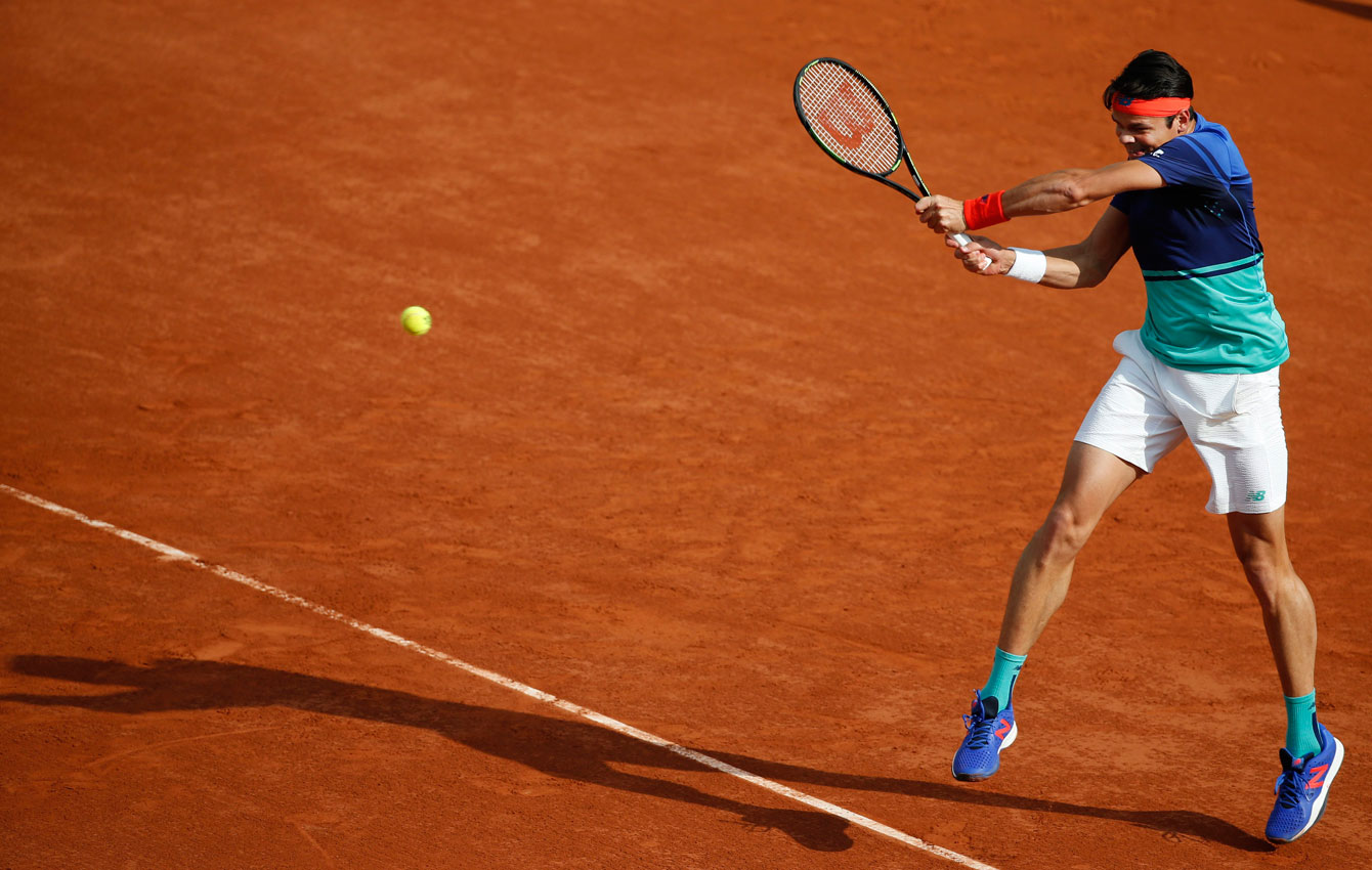 Milos Raonic returns a shot against Adrian Mannarino on May 25, 2016 at the French Open. 