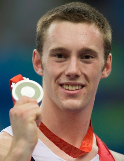 Jason Burnett Canada's Jason Burnett, from Etobicoke, Ont. holds up his silver medal following competition in the mens trampoline final at the the Beijing Olympics in Beijing, China Tuesday, Aug.19, 2008. THE CANADIAN PRESS/Adrian Wyld