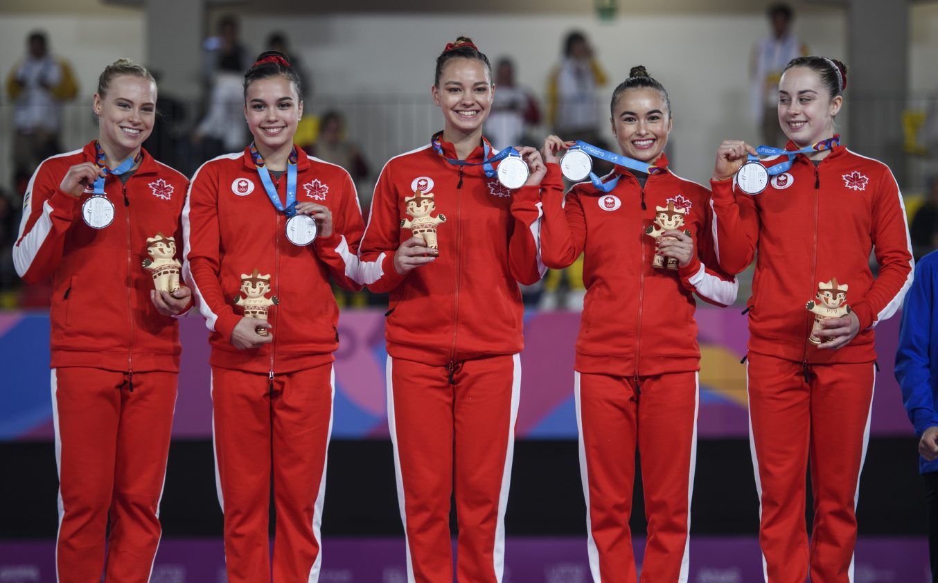 Canadian artistic gymnastics team members on podium