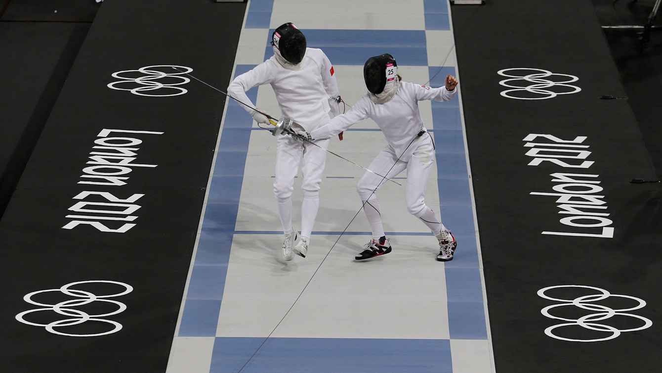 Canada's Donna Vakalis, right, competes against China's Chen Qian, left, during the fencing portion of the women's modern pentathlon competition at the 2012 Summer Olympics Sunday, Aug. 12, 2012, in London. (AP Photo/Hussein Malla)