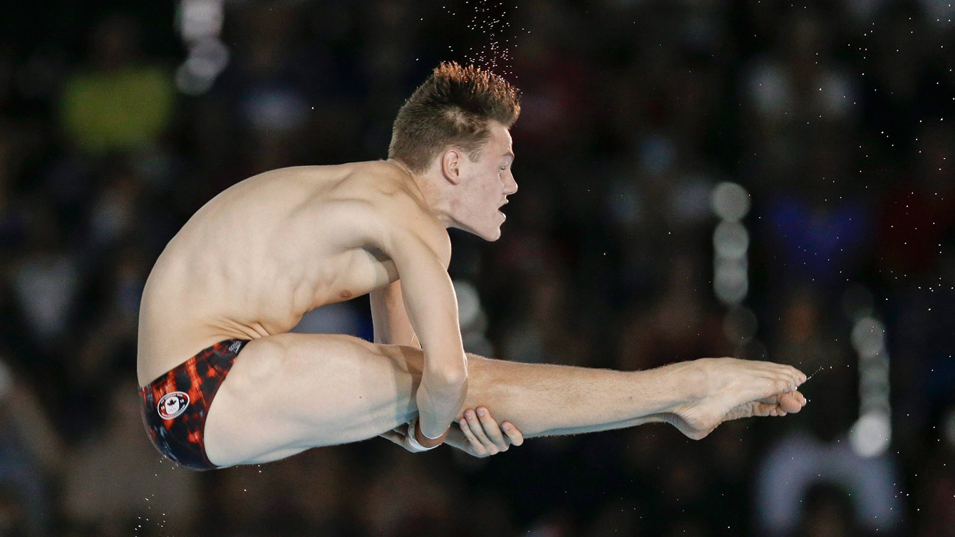 Vincent Riendeau dives during the preliminary round of the men's 10m platform event at the Pan Am Games Sunday, July 12, 2015, in Toronto. (AP Photo/Mark Humphrey)
