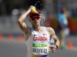 Mathieu Bilodeau running while pouring water on head