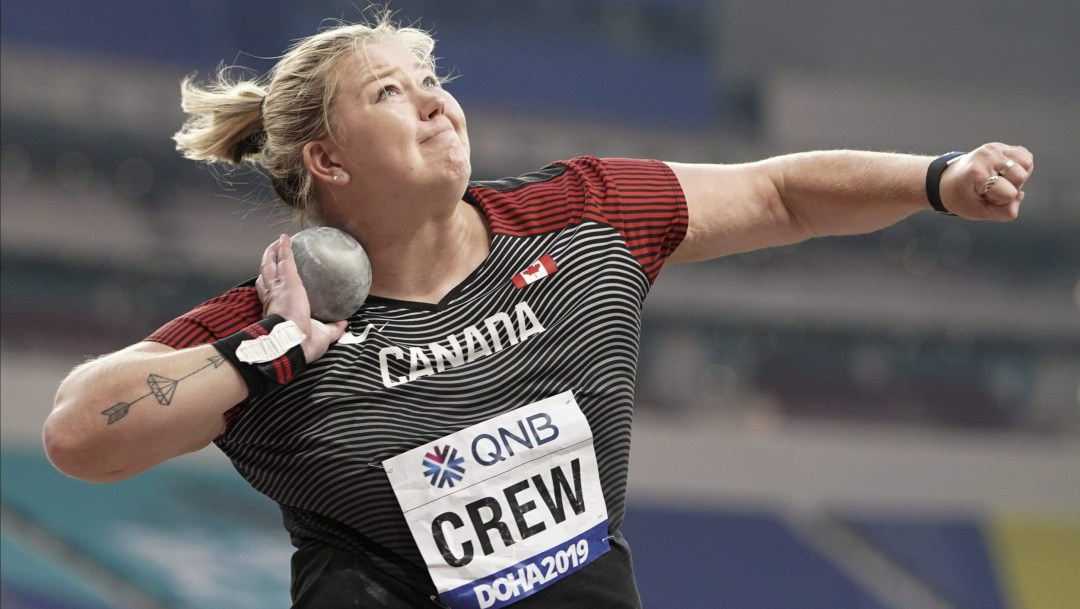 Brittany Crew with shot put by neck ready to throw