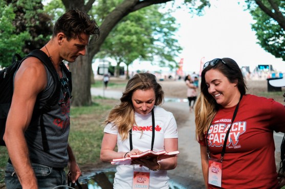 Rosie MacLennan and Martin Reader play with the Team Canada Twitter mirror. 