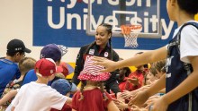 Nayo Raincock-Ekunwe runs through a crowd of children before heading onto the stage for the Team Canada basketball announcement on July 22, 2016. (Tavia Bakowski/COC)