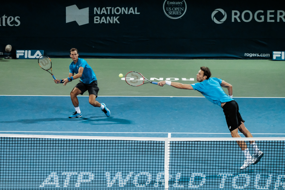 Canada’s Vasek Pospisil and Daniel Nestor play doubles in the quarterfinals of the Rogers Cup in Toronto on July 29, 2016. (Thomas Skrlj/COC)