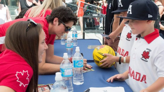 photo8 Britt Benn and Natasha Watcham-Roy signing autographs for fans after the Team Canada Rugby send-off on July 26, 2016. (Tavia Bakowski/COC)