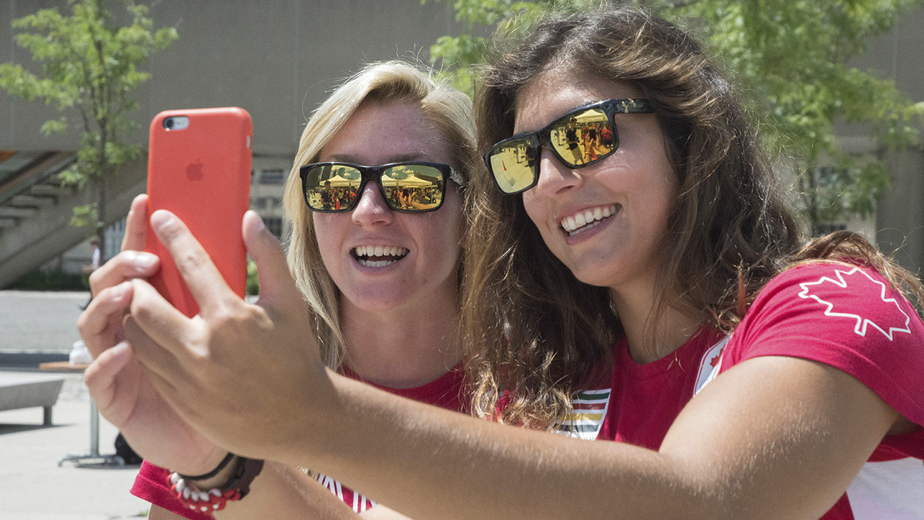 Kayla Moleschi and Bianca Farella taking a snapchat after the Team Canada Rugby send-off celebration on July 26, 2016. (Tavia Bakowski/COC)