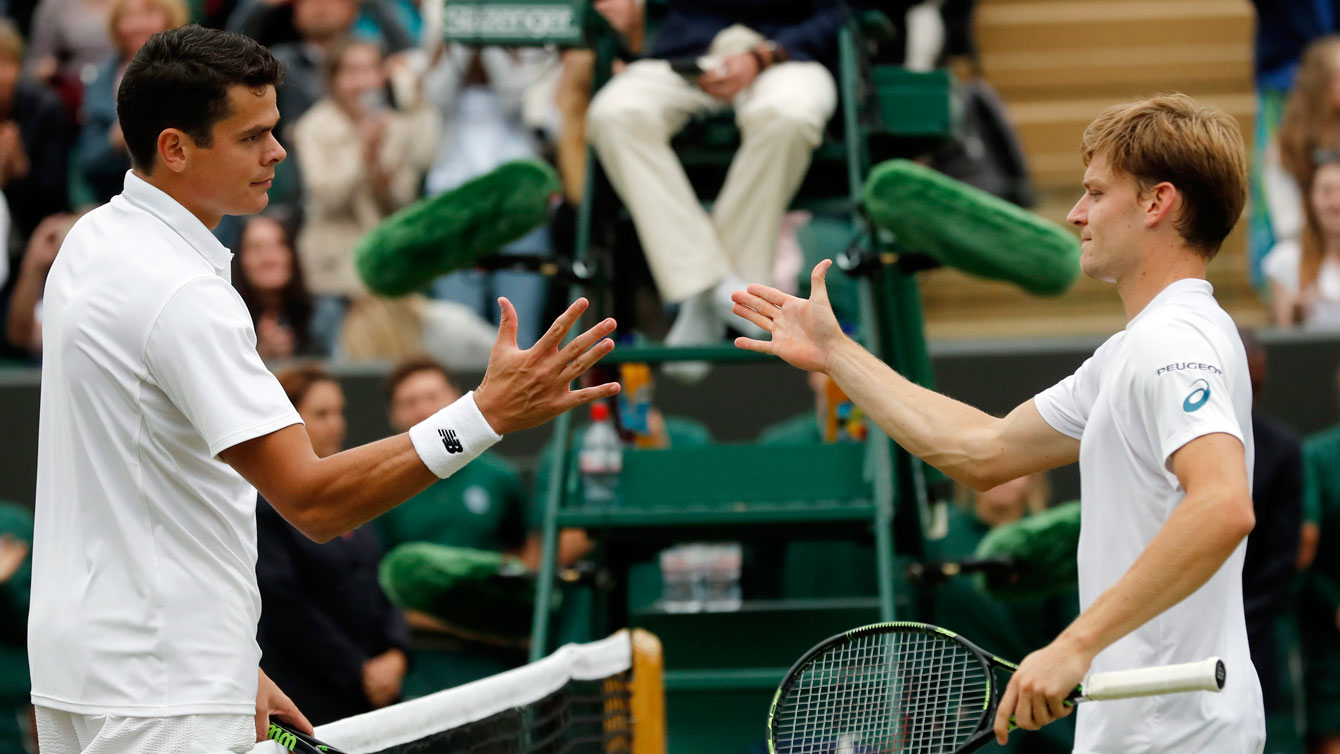 Milos Raonic (left) shakes hands with David Goffin after their fourth round Wimbledon match on July 4, 2016.