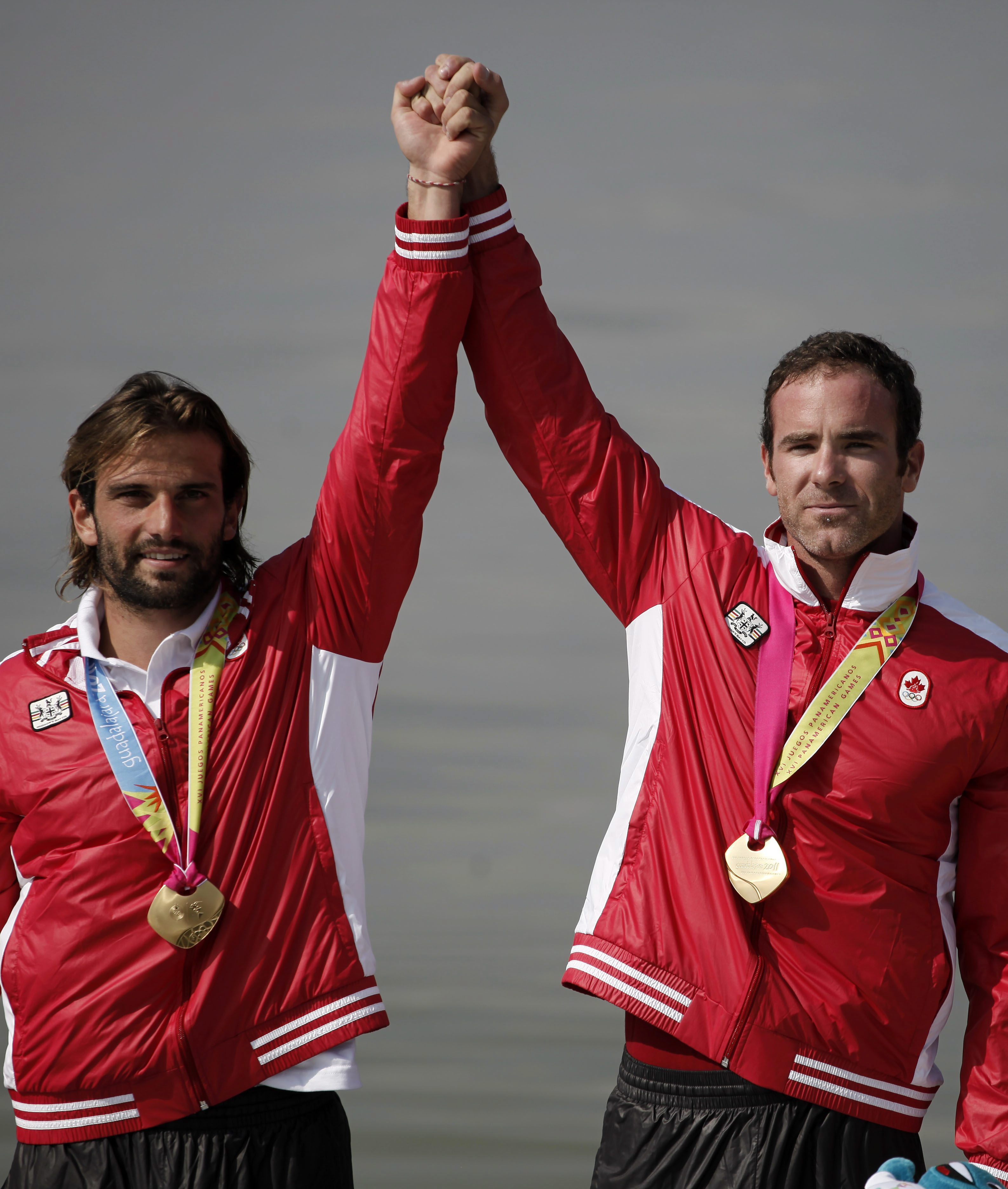 Gold medal winners Hugues Fournel, left, and Paul Cochrane from Canada celebrate on the winner's podium during the awards ceremony for the men's double K2 200m kayak event at the Pan American Games in Ciudad Guzman, Mexico, Saturday Oct. 29, 2011. (AP Photo/Eduardo Verdugo)